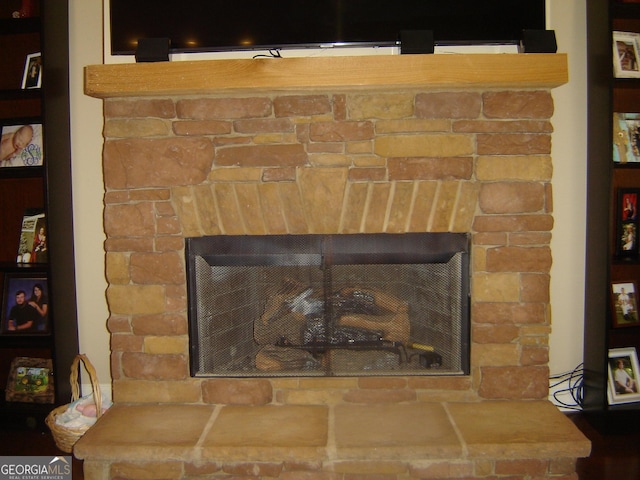 interior details featuring a stone fireplace