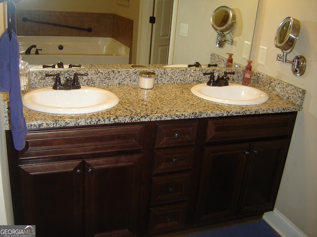 bathroom with a bath and vanity