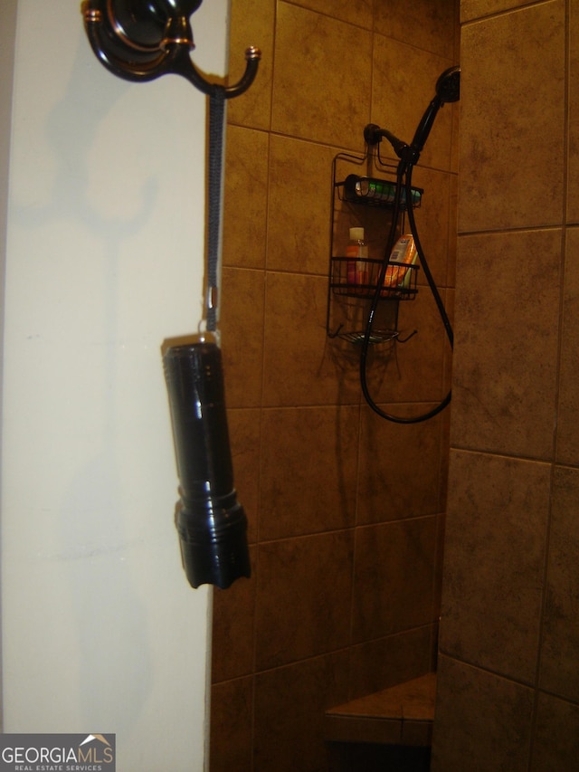 bathroom with a tile shower