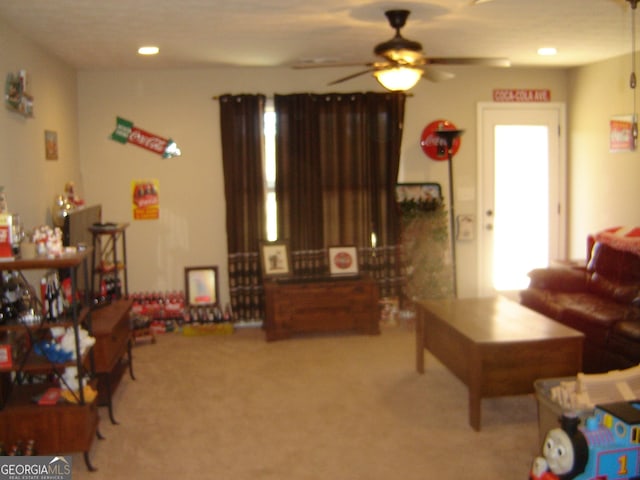 living room with carpet flooring and ceiling fan