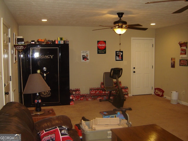 game room with ceiling fan, carpet floors, and a textured ceiling