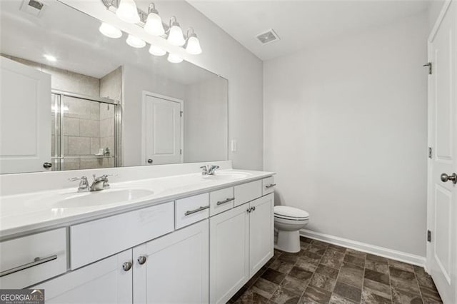 bathroom with vanity, toilet, and an enclosed shower