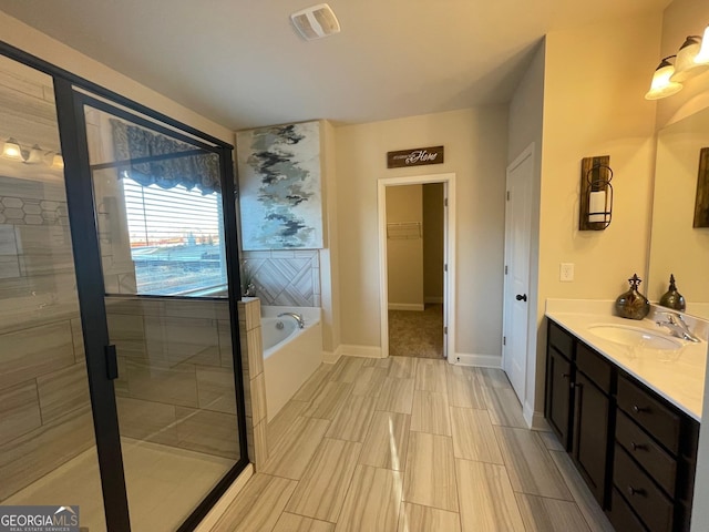 bathroom with vanity and separate shower and tub