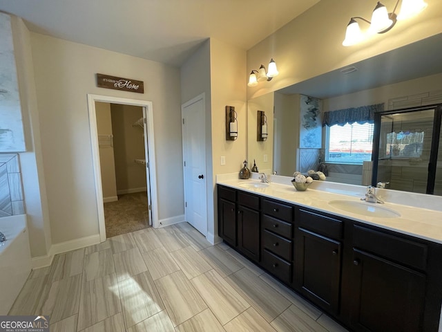 bathroom featuring vanity and independent shower and bath