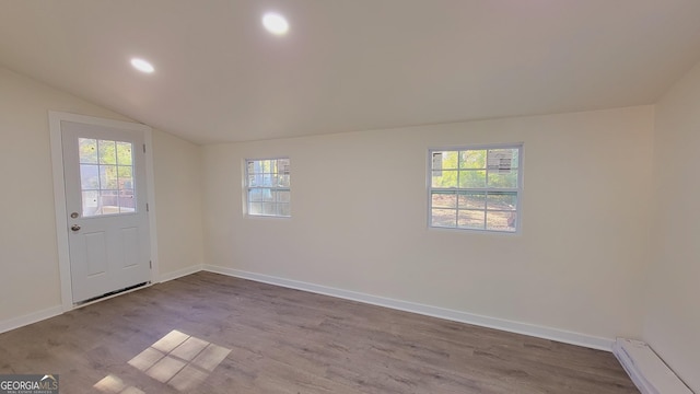 interior space with hardwood / wood-style floors, a healthy amount of sunlight, and baseboard heating