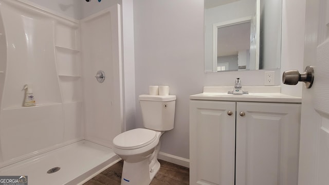 bathroom with vanity, toilet, wood-type flooring, and walk in shower