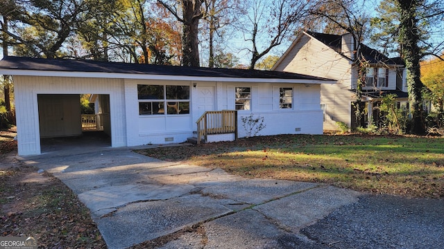 view of front facade with a carport and a front lawn