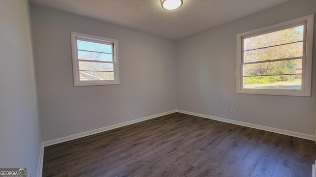 empty room with dark hardwood / wood-style floors