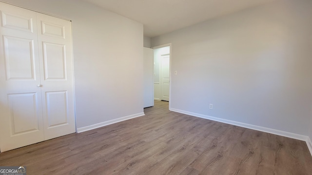 unfurnished bedroom featuring a closet and light hardwood / wood-style flooring