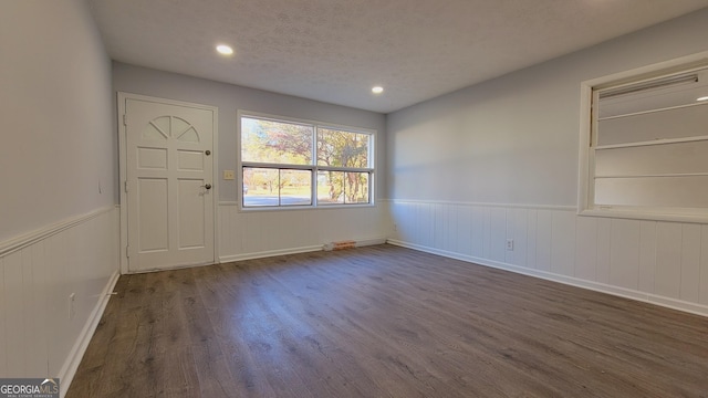 interior space with dark hardwood / wood-style flooring and a textured ceiling