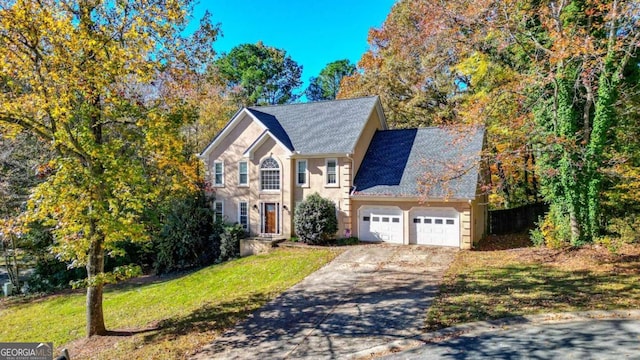 view of front facade featuring a front yard and a garage