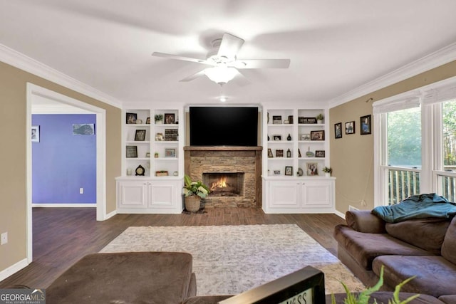 living room with dark wood-style floors, a fireplace, crown molding, and baseboards