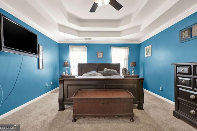 bedroom with a raised ceiling, carpet flooring, baseboards, and ceiling fan