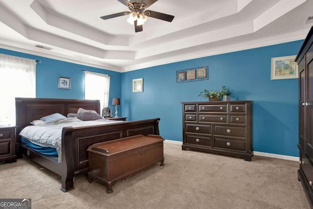 carpeted bedroom featuring visible vents, a raised ceiling, and baseboards