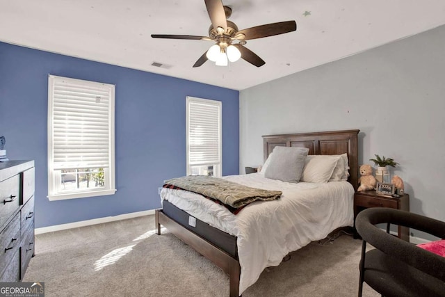 bedroom featuring visible vents, baseboards, carpet, and a ceiling fan