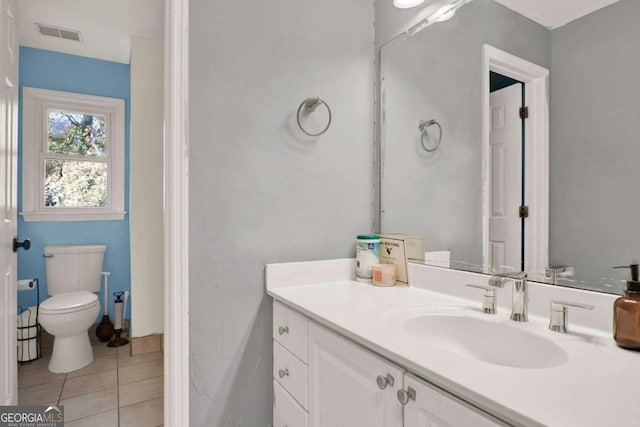 bathroom with vanity, tile patterned floors, toilet, and visible vents