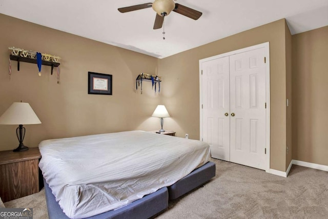 bedroom with a closet, carpet floors, baseboards, and a ceiling fan