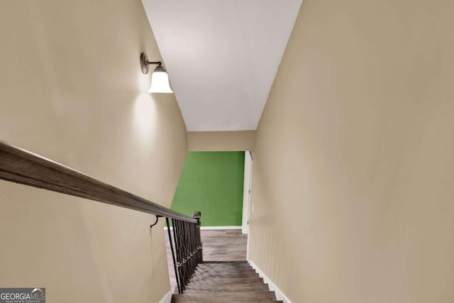 stairs featuring wood finished floors and baseboards