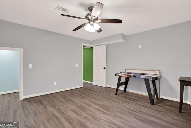 game room featuring visible vents, a ceiling fan, baseboards, and wood finished floors