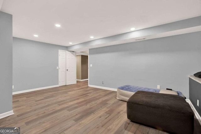 sitting room featuring recessed lighting, baseboards, and wood finished floors