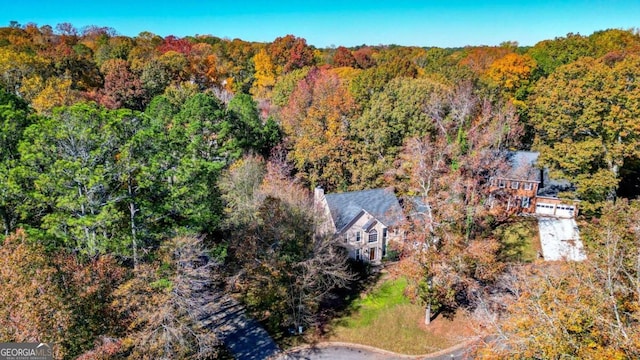 birds eye view of property with a view of trees