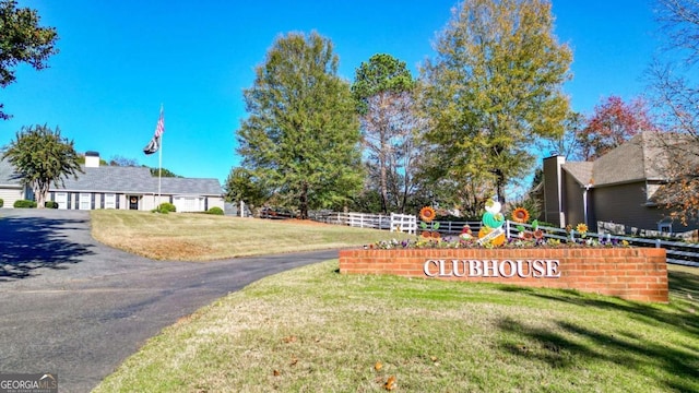 exterior space featuring a lawn, a garage, and fence