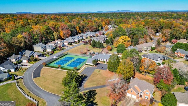 birds eye view of property with a wooded view and a residential view