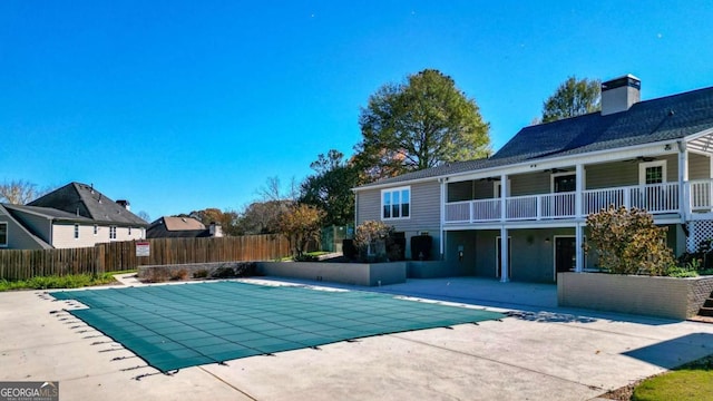 view of swimming pool featuring a fenced in pool, a patio, ceiling fan, and fence