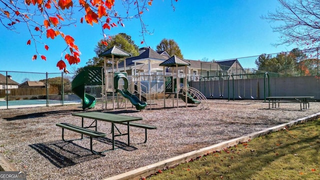 community playground featuring a residential view and fence