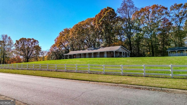 view of front of property with a front yard and fence