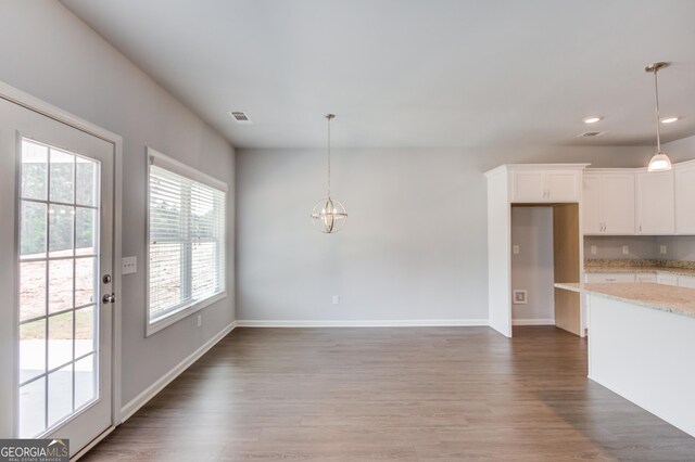 interior space with hardwood / wood-style flooring and an inviting chandelier