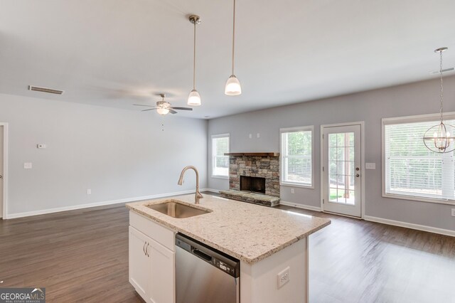 kitchen with dark hardwood / wood-style flooring, stainless steel dishwasher, sink, decorative light fixtures, and white cabinetry