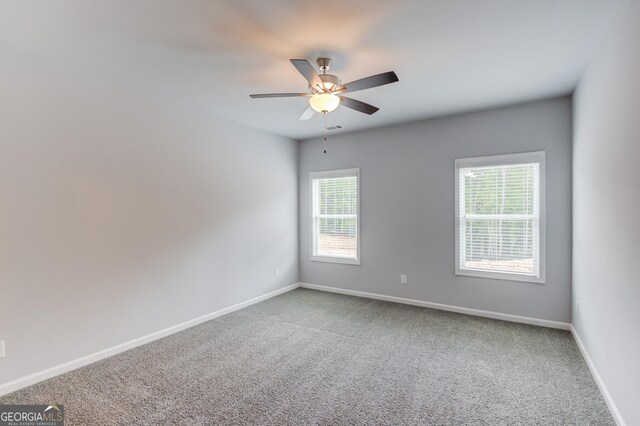 empty room with carpet flooring and ceiling fan