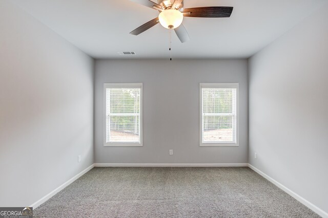 carpeted spare room with ceiling fan and a healthy amount of sunlight