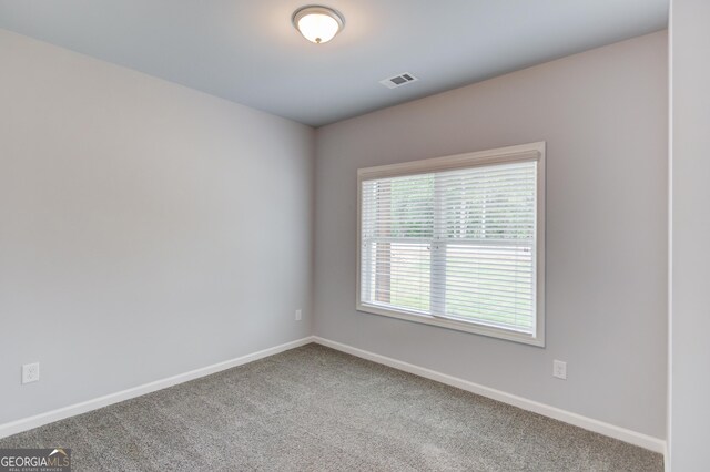 empty room with carpet flooring