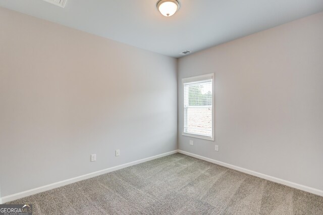 unfurnished room with carpet flooring