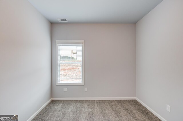 spare room with light colored carpet