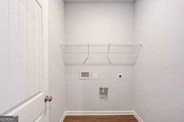 laundry room with hookup for an electric dryer, hookup for a washing machine, and dark wood-type flooring