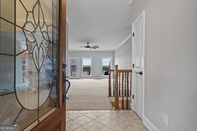 hall featuring ornamental molding and light carpet