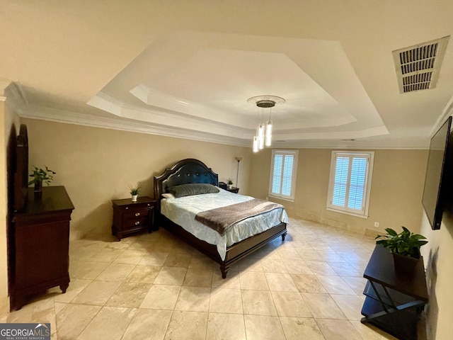 bedroom featuring a raised ceiling and ornamental molding