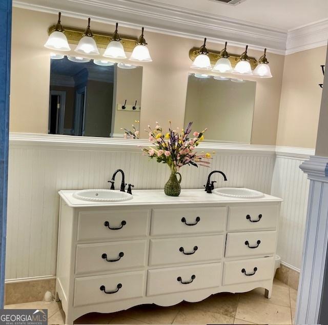 bathroom with tile patterned flooring, vanity, and ornamental molding