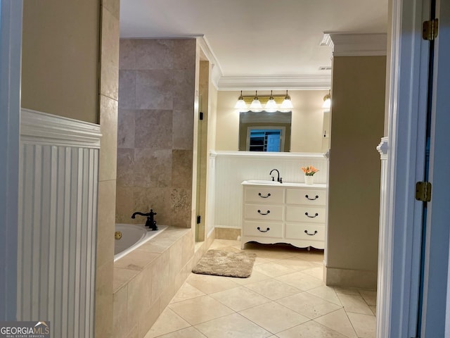 bathroom with tile patterned floors, tiled bath, crown molding, and vanity