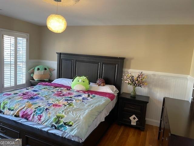 bedroom featuring vaulted ceiling and dark hardwood / wood-style floors