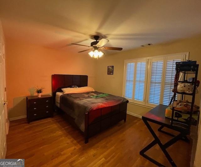 bedroom featuring ceiling fan and wood-type flooring