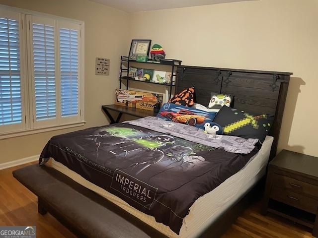 bedroom with hardwood / wood-style flooring