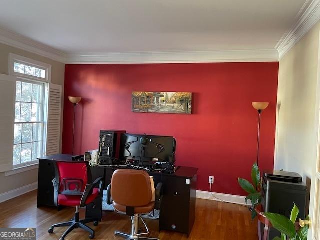 office with dark hardwood / wood-style flooring, ornamental molding, and a wealth of natural light