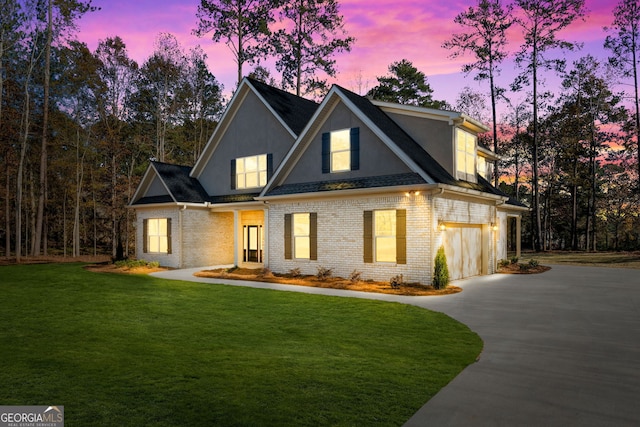 view of front of property featuring a garage and a yard