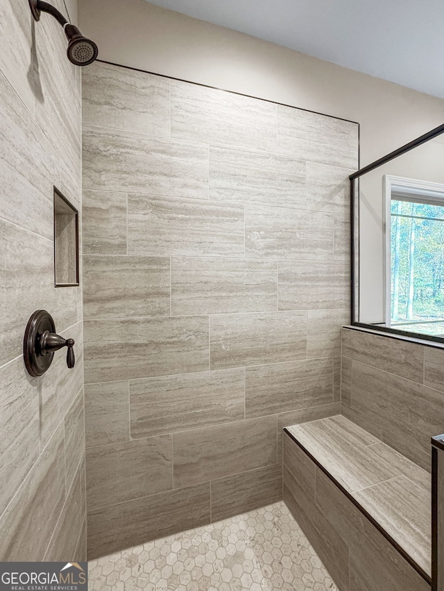 bathroom with tiled shower