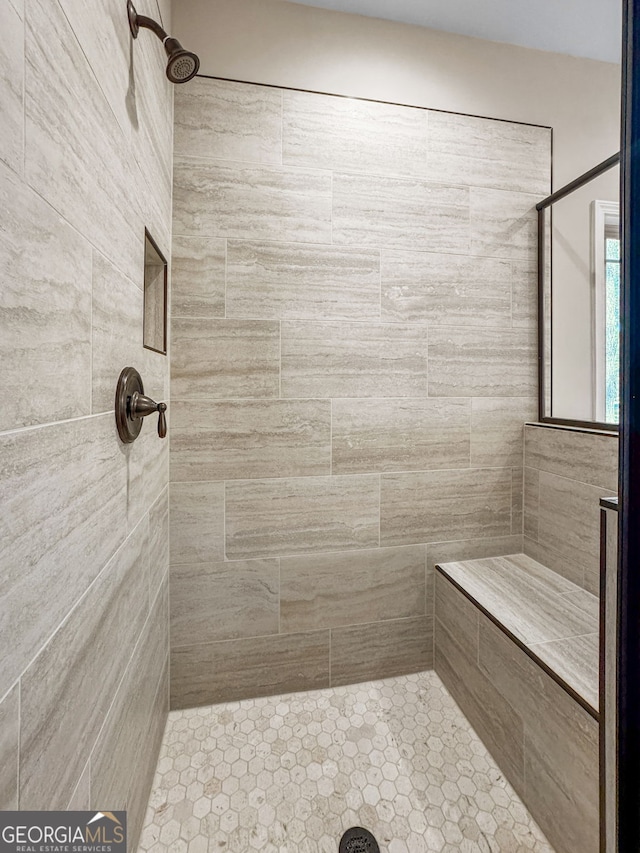 bathroom with tiled shower