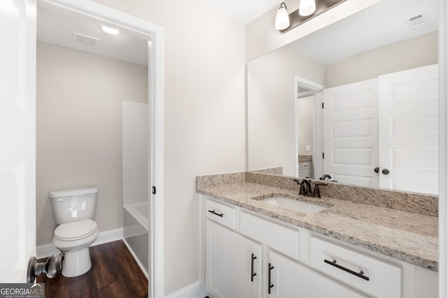 bathroom with vanity, toilet, and wood-type flooring